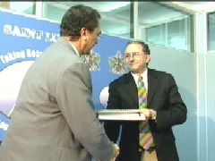 Prime Minister Dr. Kenny D. Anthony accepting the report from Chairman of the NEC Richard Peterkin