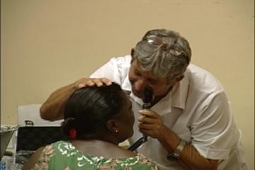 Cuban specialist examining eye patient