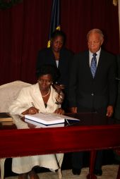 Her Excellency Dame Pearlette Louisy cementing the official swearing in of the Right Hon. John G.M. Compton as Prime Minister of Saint Lucia