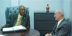 Minister of Communications Felix Finisterre discusses postal reform with Executive Director General of the Universal Postal Union, Thomas Leavy