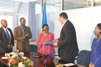 Prime Minister, Dr. Kenny D. Anthony exchanges a signed agreement with Deputy Secretary General of the Commonwealth, Mrs. Florence Mugasha. Looking on (from left) are, Marcellus Joseph, General Manager of BELfund; Armstrong Alexis, Regional Director of the Commonwealth Youth Development Fund; and Hon. Menissa Rambally, Minister of Social Transformation, Culture and Local Government.