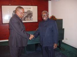 Mr. Henry Charles, at left, is greeted by His Excellency President Ronald Venetiaan.