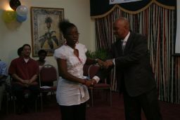 Cabinet Secretary, Cosmos Richardson Presents Certificate to Participant